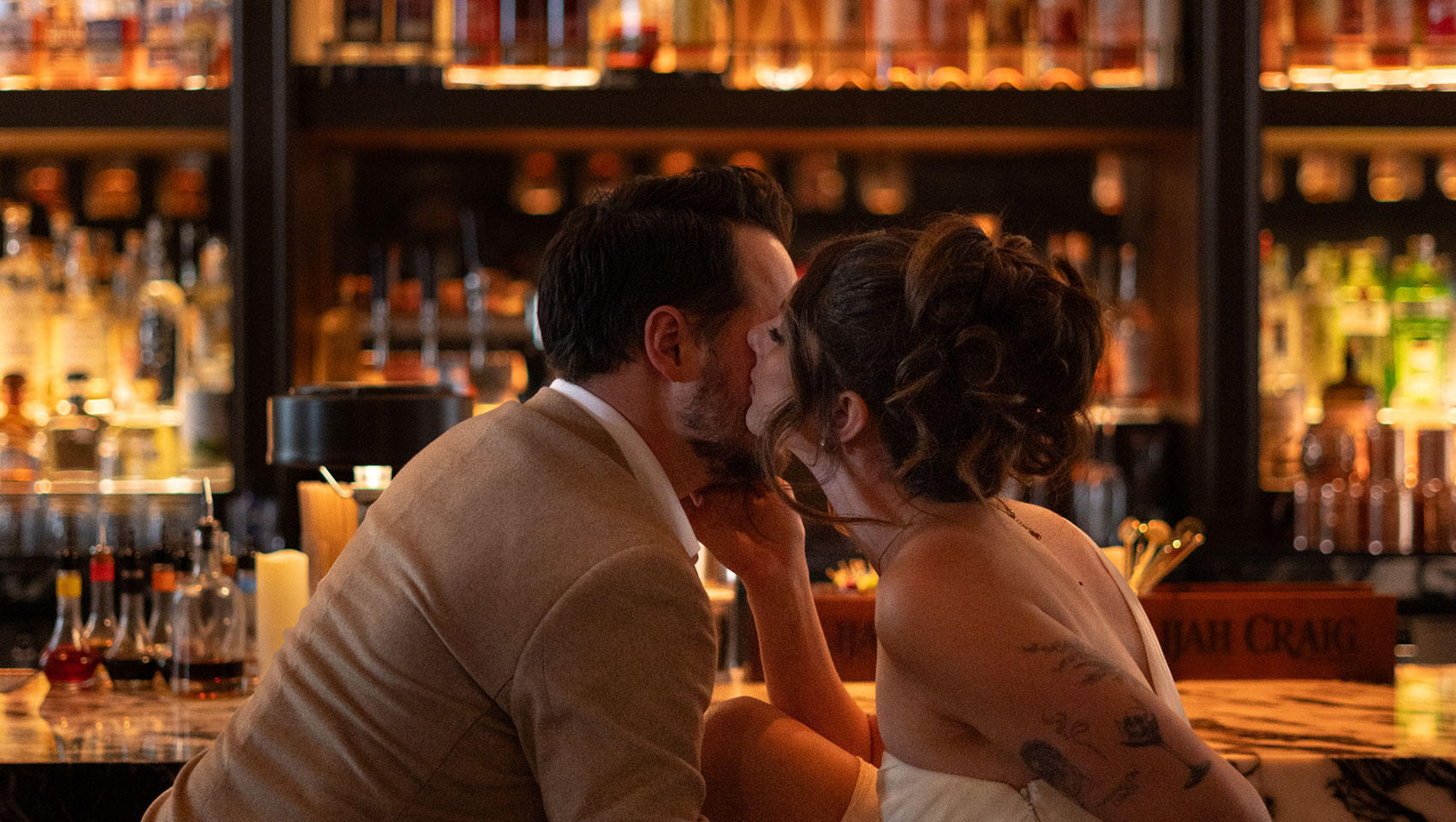 Newlyweds kiss in bar
