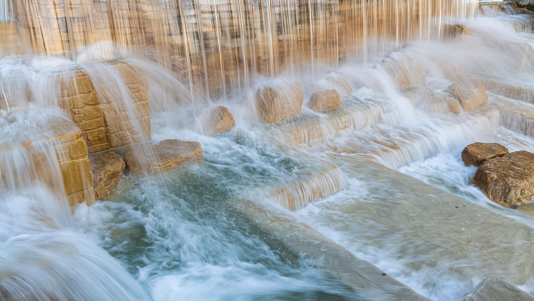 Stone waterfall and flowing water feature near San Antonio Riverwalk