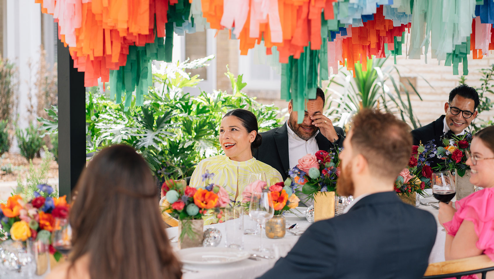 Newlyweds + Guests at reception table