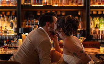 Newlyweds kiss in bar
